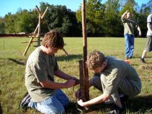 Scouts attach a 6' stave to a pioneering stake with two round lashings.
